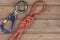 Figure eight knot with climbing carabiner and rappel eight on wooden background.