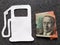 figure of gasoline pump in white and an australian banknote of twenty dollars