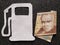 figure of gasoline pump in white and a peruvian banknote of twenty soles