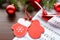 Figure mittens and balls fir branch on a wooden background