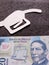 figure of the pistol of a gasoline bomb in white and a mexican banknote of twenty pesos