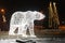 Figure of a polar bear from a garland of lights in the evening on a city street