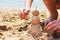 Figure of sand on the background of the river, glasses, flip-flops