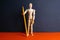 The figure of a wooden man holds pencil. Front views