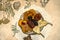 Figured napkin with small eclairs,a crystal rosette with dried fruits lying on plywood