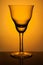 Figured wine glass for sherry on a background of orange spotlight