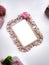 Figured wooden frame surrounded romantic details on white background.
