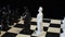 Figures of white and black chess king`s stand opposite each other on a black-and-white chessboard. Chess pieces in the