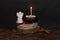 Figurine angel and cake with a candle, background image for congratulations