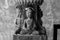 A figurine of Buddha. Buddha Shakyamuni. Decoration of the ancient temple in Kathmandu. Three faces of the great genius.