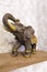 A figurine of an elephant on a shelf luck, happiness in the house
