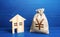 Figurine silhouette house and chinese yuan or japanese yen money bag. Buying and selling real estate. Maintenance, property