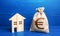 Figurine silhouette house and euro money bag. Buying and selling real estate. Taxes. Mortgage loan. Sale of housing. Proposal for