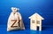 Figurine silhouette house and polish zloty money bag. Buying and selling real estate. Taxes. Mortgage loan. Sale of housing.