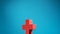 Figurine wooden cross on blue background