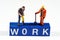 Figurines on top of the word work