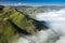 Fiji aerial of green mountains with thick white fog