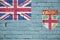 Fiji flag is painted onto an old brick wall