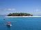 Fiji island best beach photo. Island with forest and cottage, natural panorama with boats with red roofs.