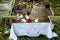 Fiji - table prepared for guests. Table decorated with white cloth and fresh flowers of the garden.