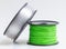 Filament for 3D Printer crystal clear and bright green against a