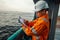 Filipino deck Officer on deck of offshore vessel or ship fills checklist. Paperwork at sea