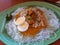 Filipino dish, pancit palabok, is a white noodle with eggs, and meat and chicharon in oarange sauce