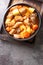 Filipino Menudo is a hearty and tasty pork stew made with fresh tomatoes, potatoes, carrots close up in the plate. Vertical top