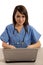 Filipino nurse doctor working on laptop