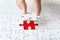 Fill the missing parts of hand white jigsaw concept puzzle for succeed