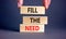 Fill the need symbol. Concept words Fill the need on wooden blocks on a beautiful grey table grey background. Businessman hand.