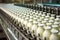 filled buttermilk bottles on a conveyor belt