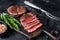 Fillet Mignon tenderloin Grilled and sliced meat beef steaks. Black background. Top view