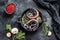 Fillet of Salted Dutch herring in a pan with onions and thyme. Black background. Top view