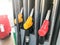 Filling colorful guns at a gas station for refueling a car with fuel, gasoline, diesel