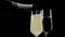 Filling flutes of champagne with golden bubbles against black background, concept of golden luxury holiday happy new year