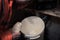 Filling the freshly brewed young beer into big bucket for fermentation during the process of brewing beer in garage at home