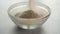 Filling a glass bowl with psyllium husk dietary fiber supplement