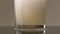 Filling glass with soda water in slow motion. Stock footage. Close up of pouring soft drink with many bubbles inside the