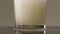 Filling glass with soda water in slow motion. Stock footage. Close up of pouring soft drink with many bubbles inside the