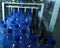 Filling line of sparkling water in pet bottle. Mini factory for bottling water