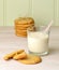 A filling snack of homemade peanut butter cookies and a refreshing glass of milk with a straw.