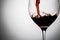 Filling wineglass of red wine closeup, image with copy space