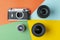 Film camera with modern lenses on a colored background, digital versus film, color rendering concept