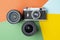 Film camera with modern lenses on a colored background, digital versus film, color rendering concept