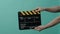 Film crew man hand hold and clap empty black and yellow stripe film slate