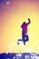 Film grain. Flying man. Young man falling down on colorful sky background.