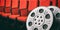 Film movie reels with blurry red theater seats background, copy space, 3d illustration.