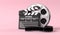 Film reel with clapperboard isolated on bright pink background in pastel colors
