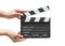 Film slate board or cinema act clapperboard on womanâ€™s hand with take, action, scence blank copyspace isolated